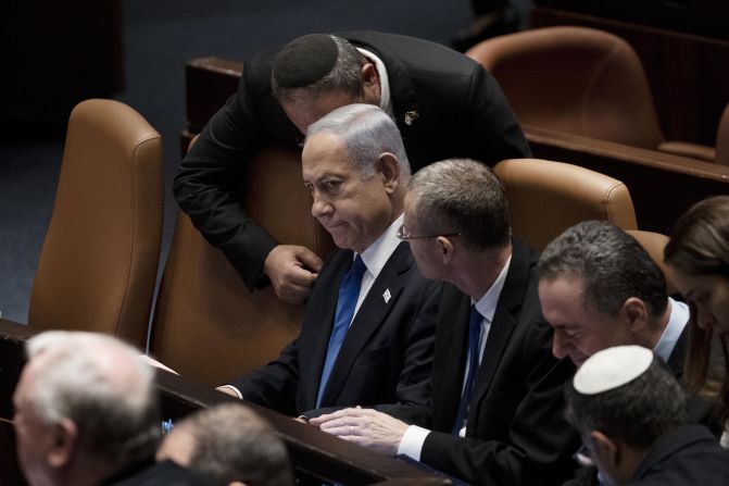 Netanyahu is surrounded by lawmakers at a session of the Knesset in July 2023. The Israeli parliament <a href="index.php?page=&url=https%3A%2F%2Fedition.cnn.com%2F2023%2F07%2F24%2Fmiddleeast%2Fisrael-supreme-court-power-stripped-intl%2Findex.html" target="_blank">passed a bill</a> stripping the Supreme Court of its power to block government decisions, the first part of a planned judicial overhaul that has sparked months of protests across Israel.