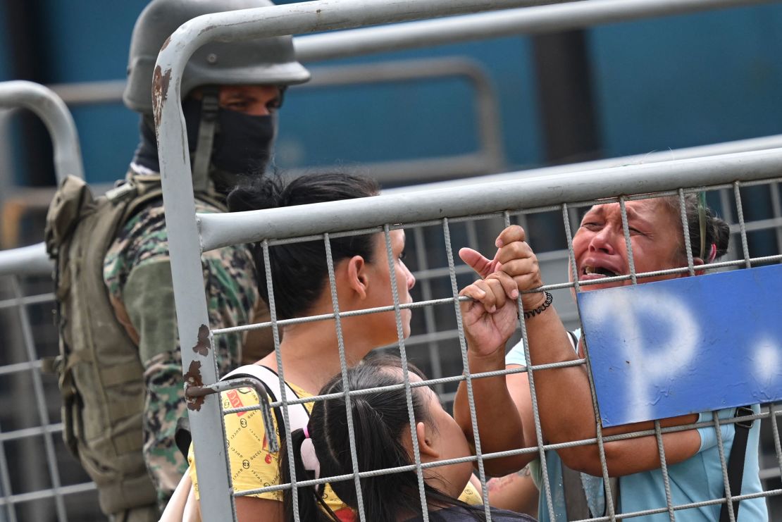 A woman cries outside outside the Guayas 1 prison a day after a fight between rival gangs left six inmates dead in Guayaquil, Ecuador, on July 24, 2023.