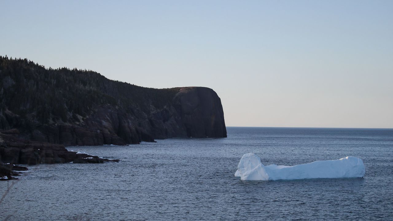 An iceberg floats in Flatrock Cove, Newfoundland, Canada. Warming oceans and melting ice threaten to desatbilize a crucial system of ocean currents in the Atlantic. 