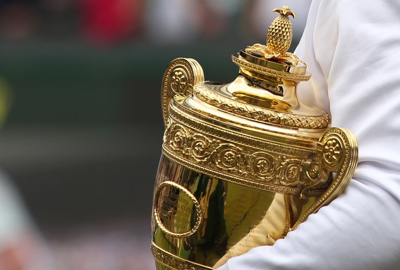 Spanish player Rafael Nadal holds the trophy after beating Czech player Tomas Berdych during the men's singles grand final of the Wimbledon Tennis Championships at the All England Tennis Club, in southwest London on July 4,  2010.   AFP PHOTO / GLYN KIRK (Photo credit should read GLYN KIRK/AFP via Getty Images)