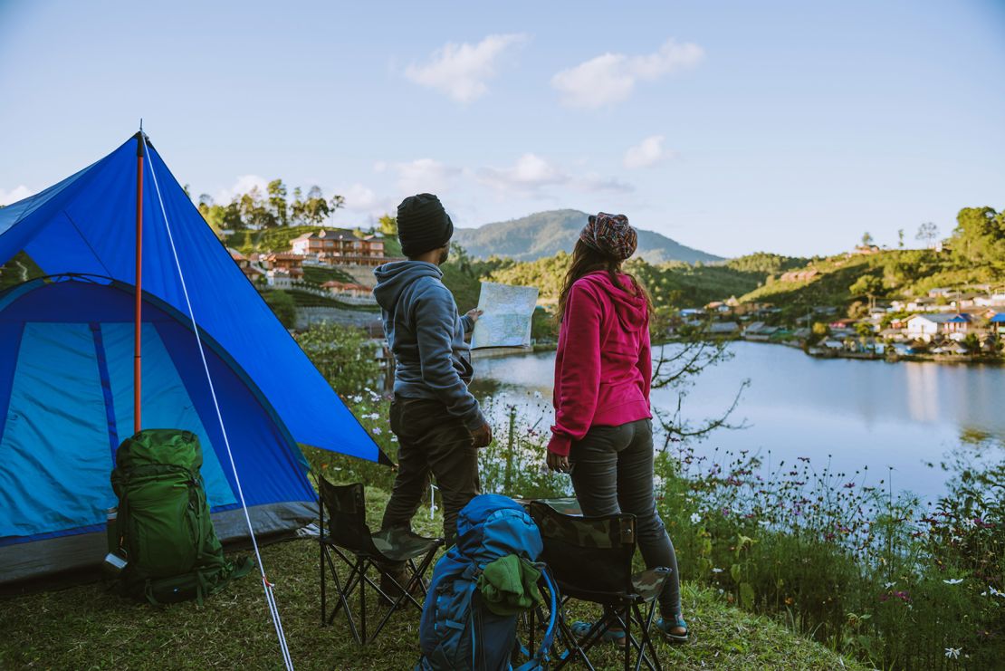 Asian couple Camp on the mountain in the upper village near the lake, Camping Travel Concept,Travel Relax concept Map.