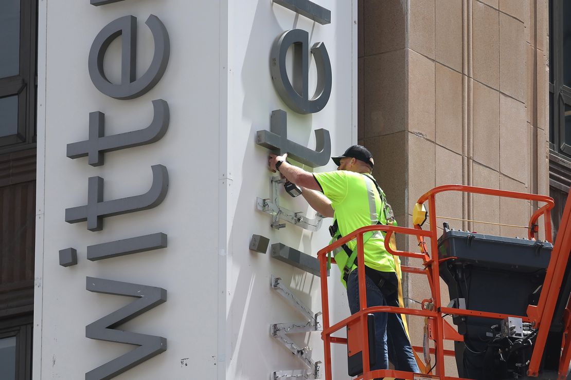 A worker removes letters from the Twitter sign that is posted on the exterior of Twitter headquarters on July 24, 2023 in San Francisco, California.