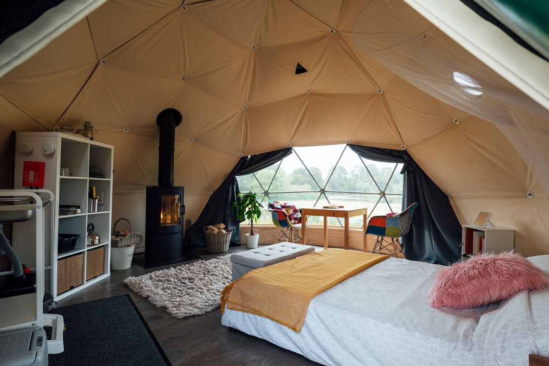 Interior of the living space of a space-age style dome tent at a glamping site in Northumberland.