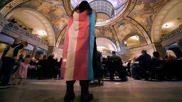 Glenda Starke wears a transgender flag as a counter protest during a rally in favor of a ban on gender-affirming health care legislation, March 20, 2023, at the Missouri Statehouse in Jefferson City, Missouri.