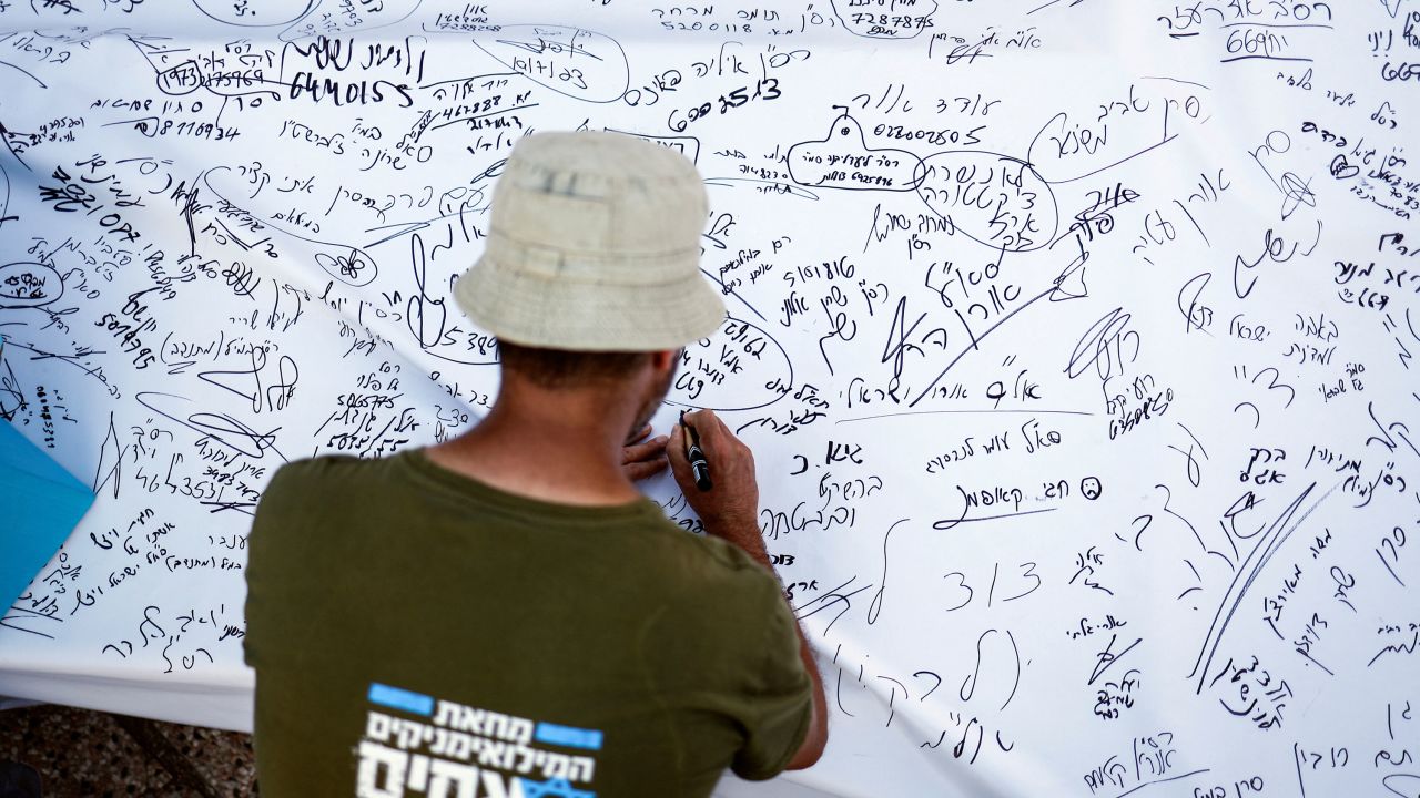 Israeli military reservist signs pledge to suspend voluntary military service if the government passes judicial overhaul legislation, near the defence ministry in Tel Aviv, Israel on July 19.