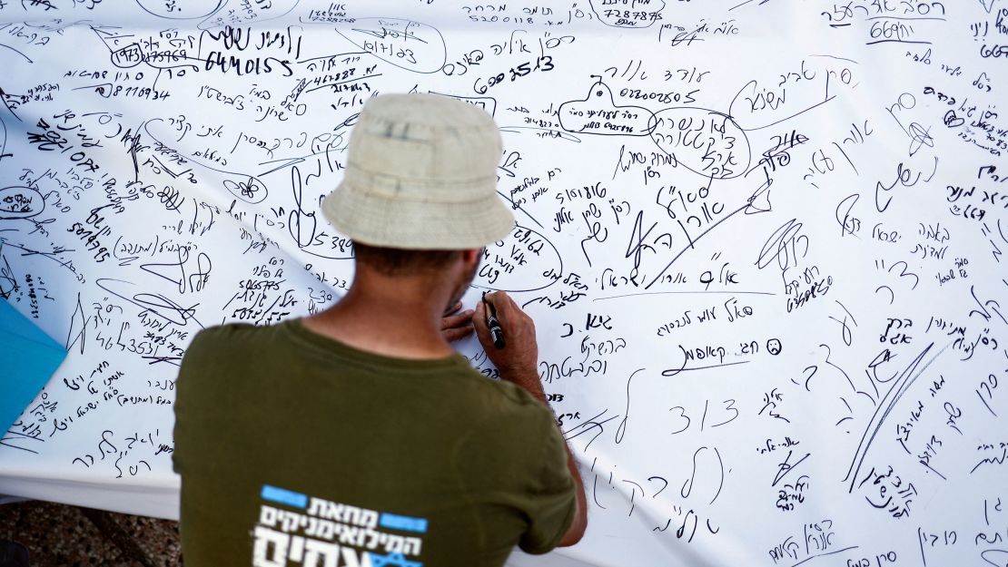 Israeli military reservist signs pledge to suspend voluntary military service if the government passes judicial overhaul legislation, near the defence ministry in Tel Aviv, Israel on July 19.