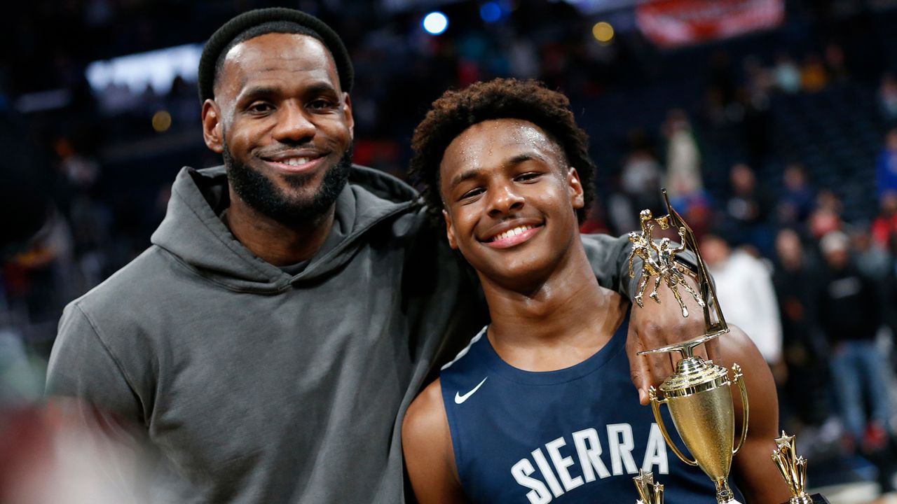 LeBron James, left, poses with his son Bronny after Sierra Canyon beat Akron St. Vincent - St. Mary in a high school basketball game, Saturday, Dec. 14, 2019, in Columbus, Ohio. (AP Photo/Jay LaPrete)