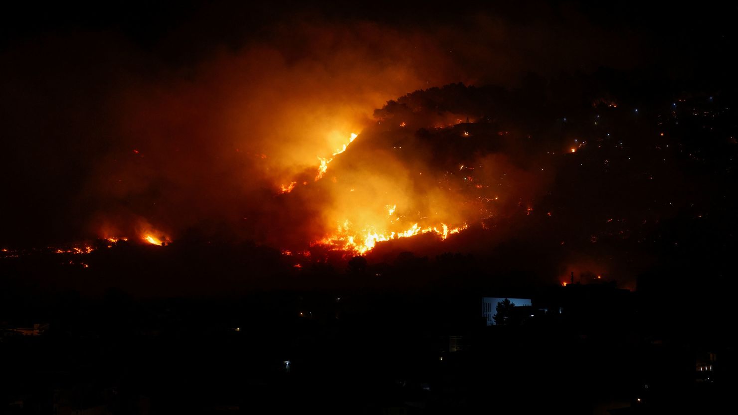 A wildfire burns in the Sicilian village of Romitello, near Palermo, Italy, July 25, 2023. 