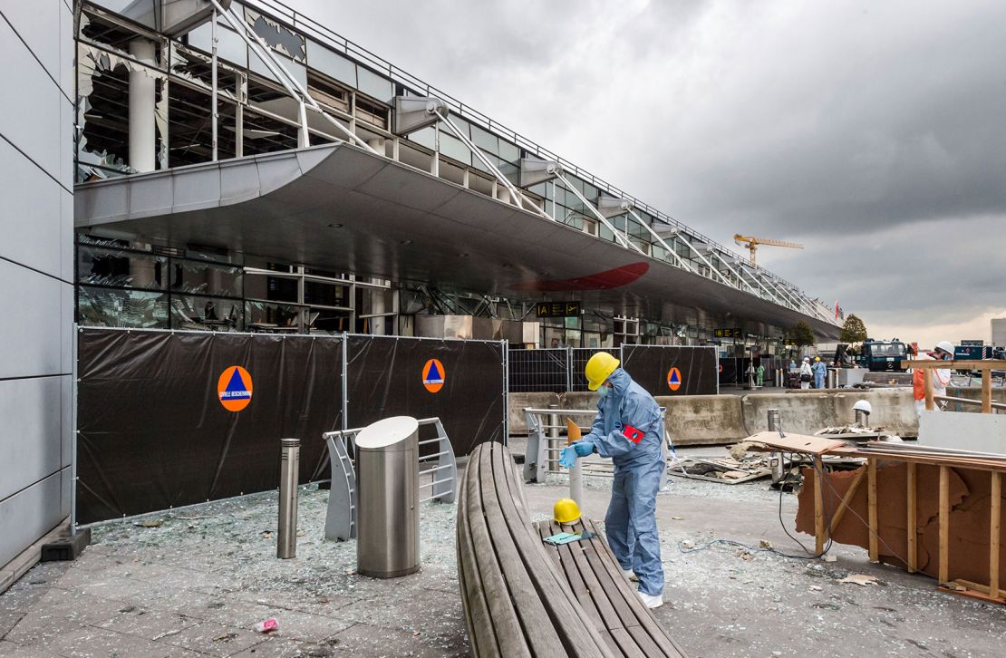 A forensics officer works in front of the damaged Zaventem Airport terminal in Brussels, March 23, 2016.