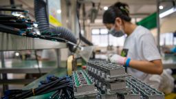 An employee works on the assembly line of LED lighting products at Pujiang Sansi Optoelectronics Technology Co., Ltd. on July 24, 2023 in Jinhua, Zhejiang Province of China.
