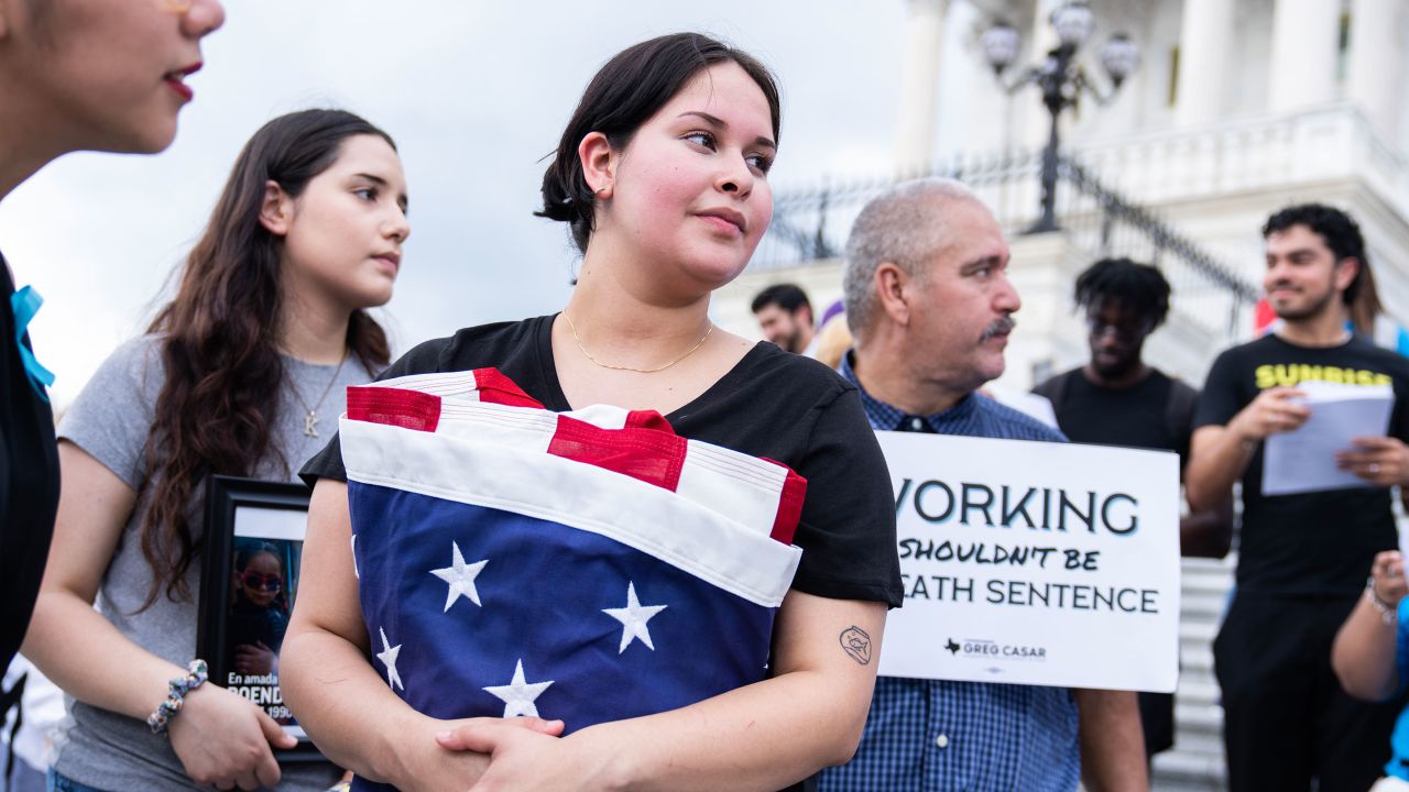 Jasmine Granillo, whose brother Roendy Granillo died from heat stroke in 2015 while working on a housing construction site, holds an American Flag presented to her by Rep. Greg Casar during a Vigil and Thirst Strike for Workers' Rights on the House steps of the U.S. Capitol on Tuesday, July 25, 2023.
