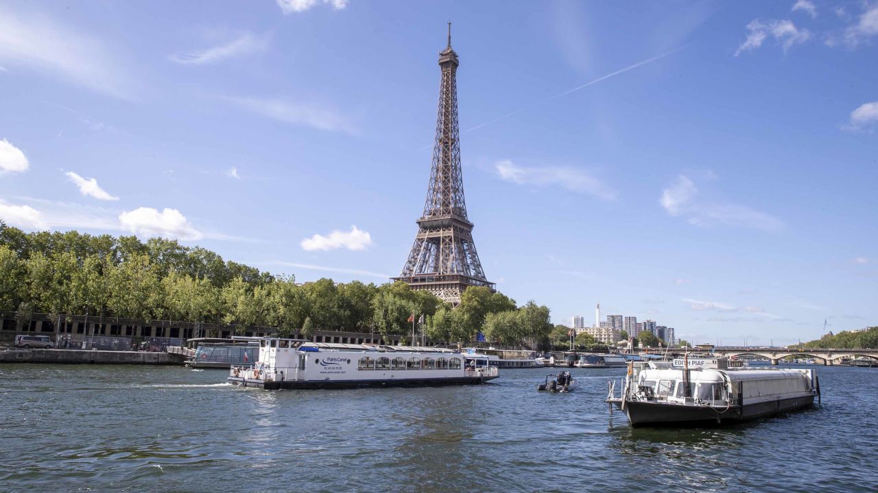PARIS, FRANCE - JULY 17: An empty boat travels the river Seine during the technical test event for the Paris 2024 opening ceremony with the Eiffel Tower in the background on July 17, 2023 in Paris, France. On July 26, 2024, for the first time in the history of the Summer Olympic Games, the opening ceremony will not be taking place in a stadium. The parade of athletes will be held on the Seine, with boats for each national delegation. Wending their way from east to west the parade will come to the end of its 6 km route in front of the Trocadéro, where the remaining elements of the Olympic protocol and final shows will take place. (Photo by Catherine Steenkeste/Getty Images)