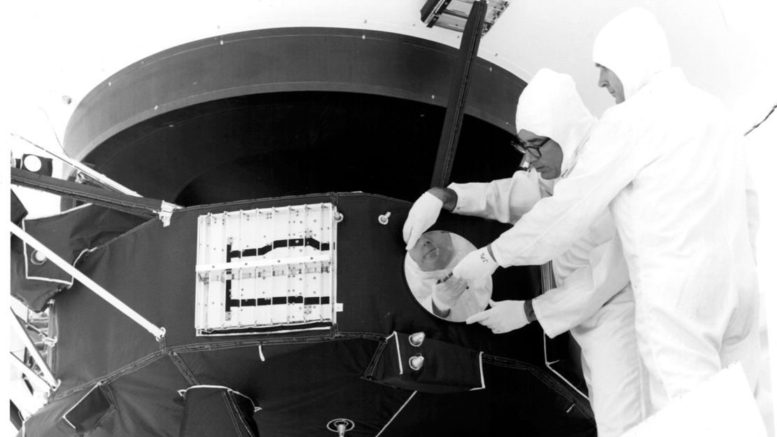 Engineers secure the cover over the Voyager 1 Golden Record in archival image from 1977.