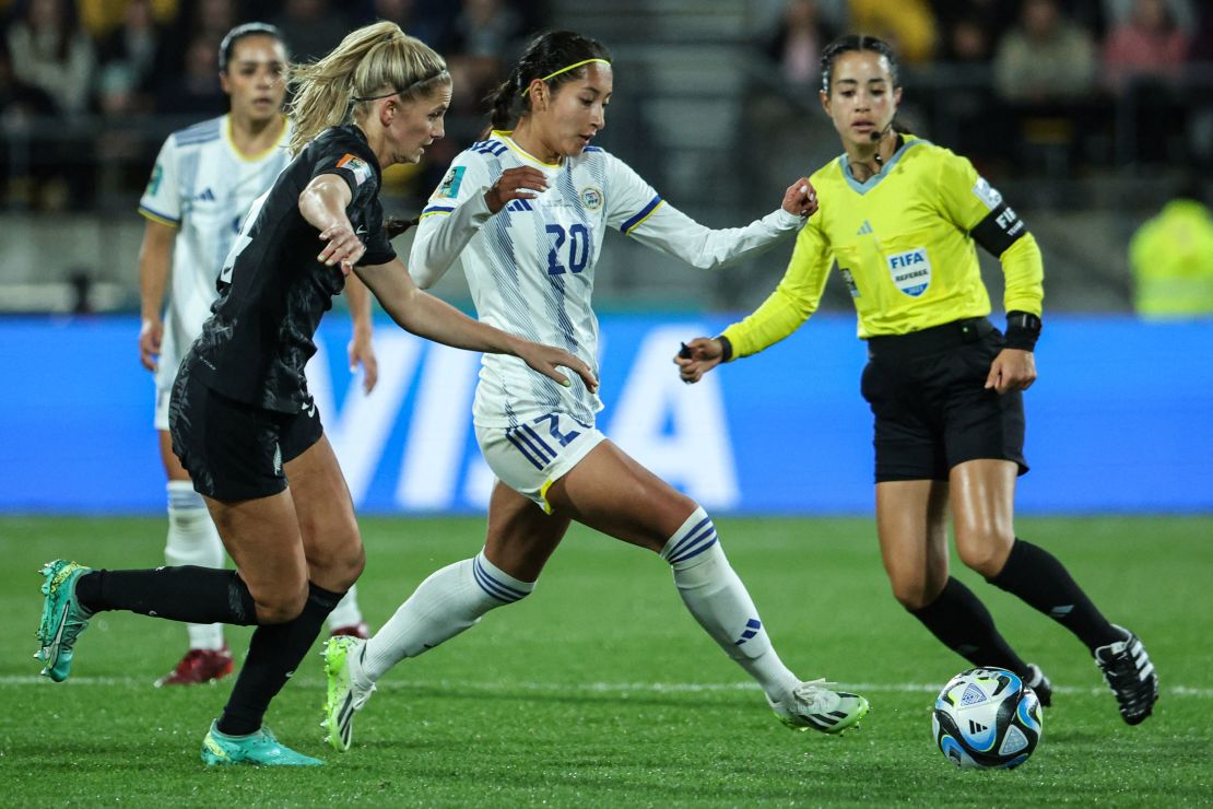 Philippines midfielder Quinley Quezada passes the ball next to New Zealand midfielder Katie Bowen. 