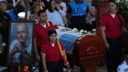 Firemen guard the coffin during the funeral of the Mayor of Manta, Agustin Intriago, who was killed by unknown assailants over the weekend in Manta, Ecuador, Monday, July 24, 2023. 