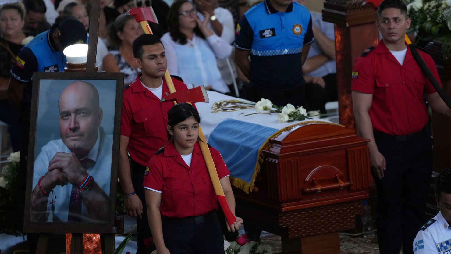 Firemen stand around the coffin during Agustin Intriago's funeral in Manta, Ecuador, Monday, July 24, 2023. 