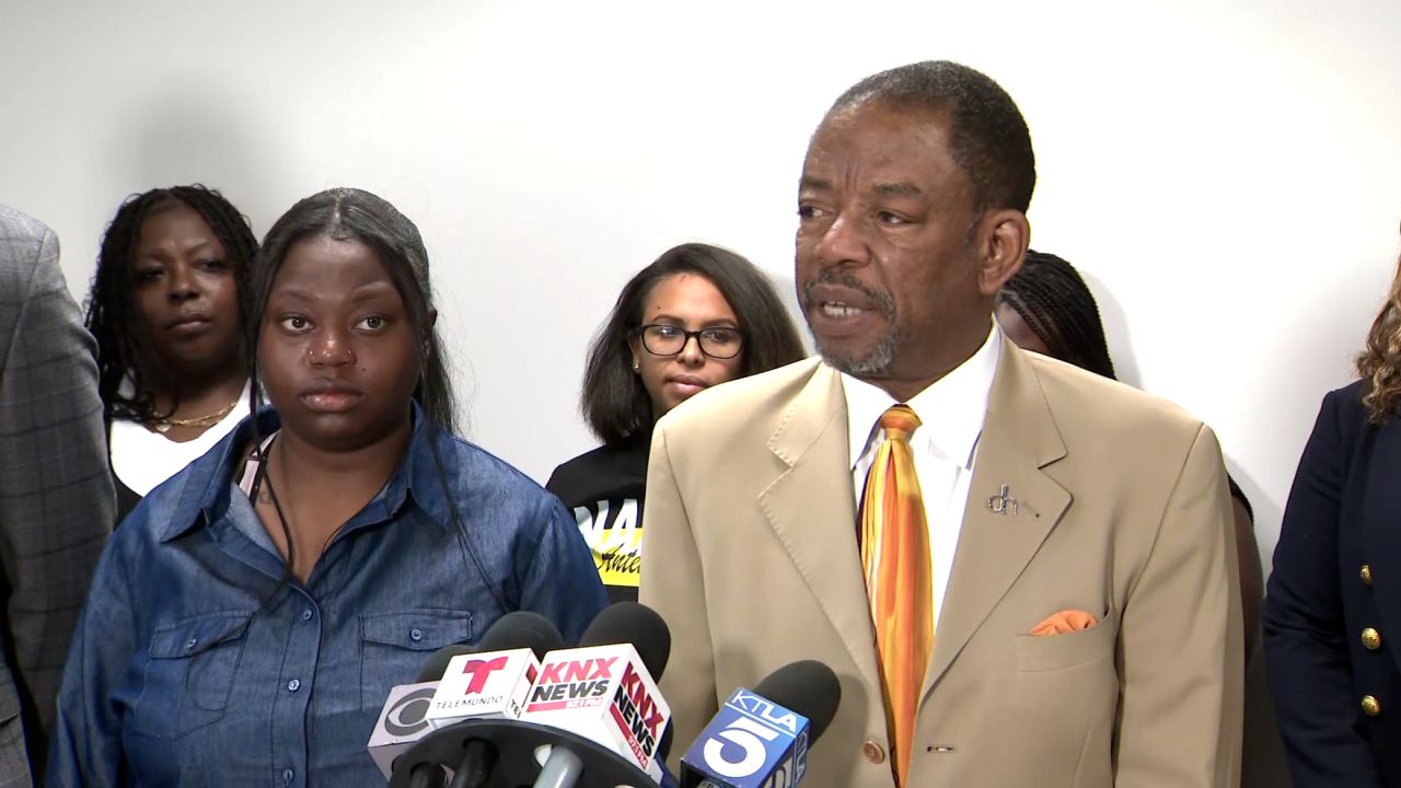 Yeayo Russell and attorney Carl Douglas during a press conference on teh lawsuit on Tuesday.