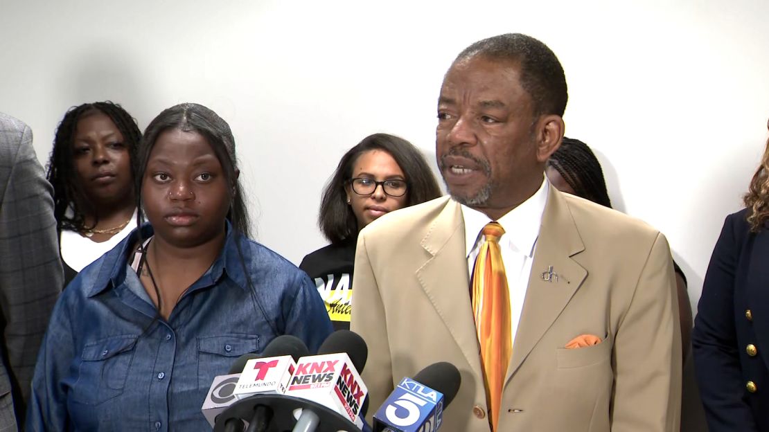 Yeayo Russell and attorney Carl Douglas during a press conference on teh lawsuit on Tuesday.