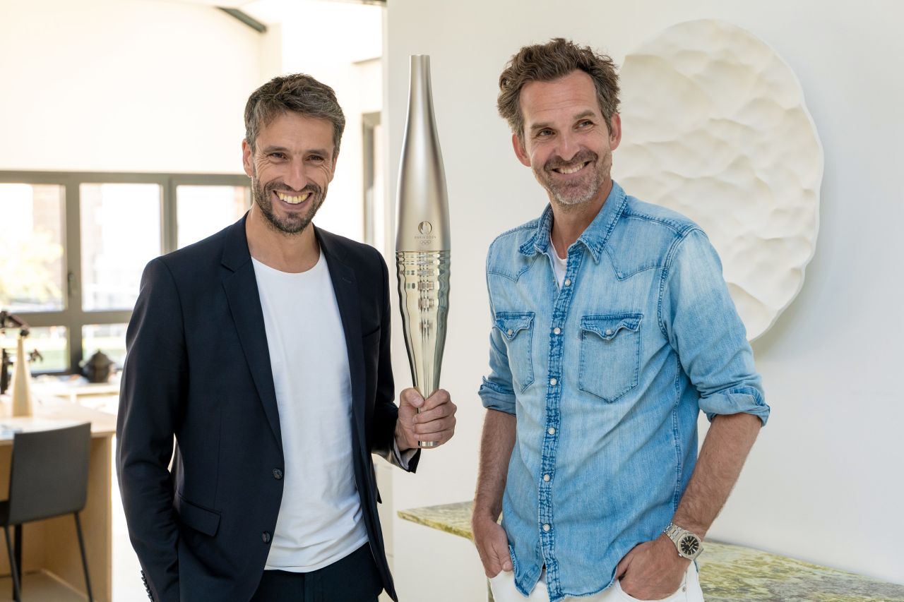 Mathieu Lehanneur, right, poses next to his design for the 2024 Paris Olympic and Paralympic Torch.
