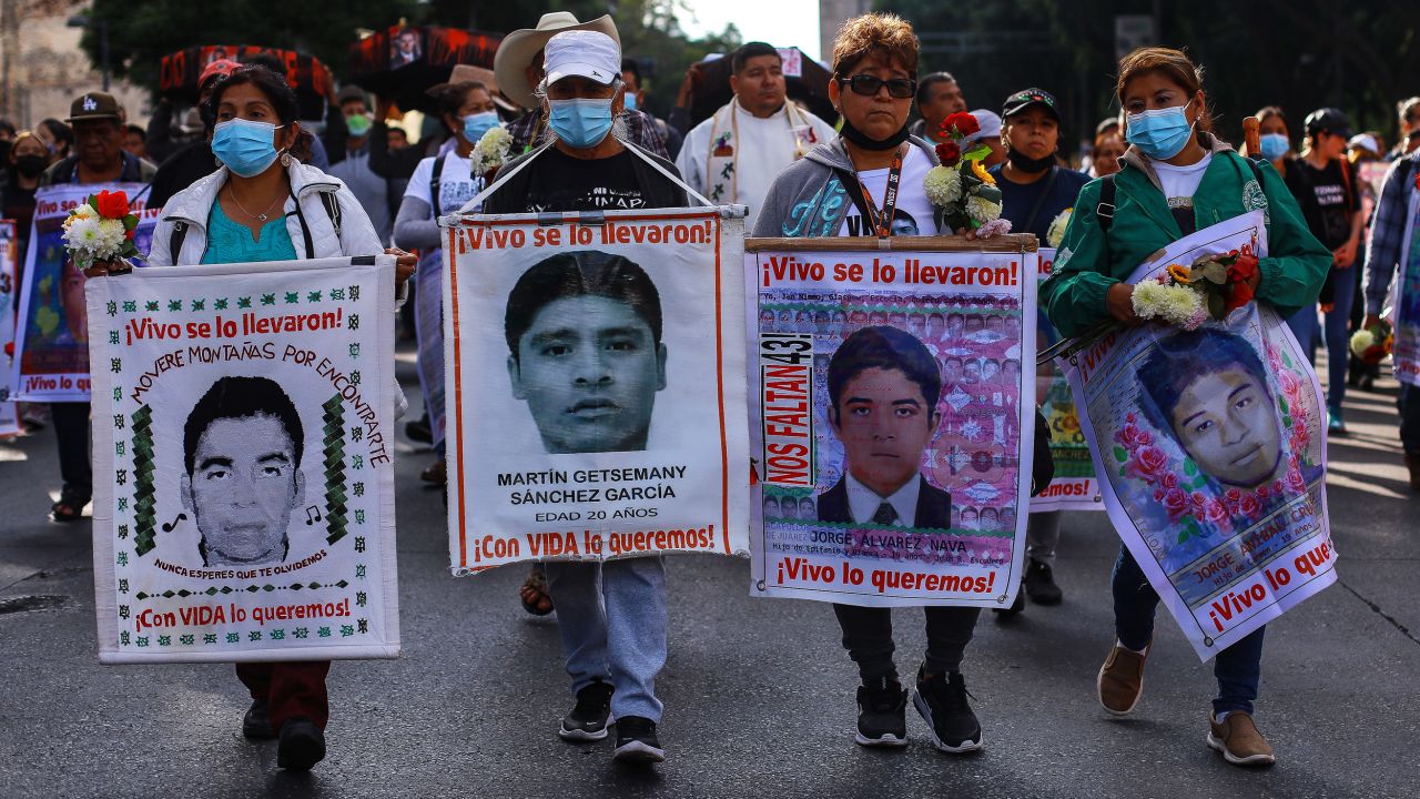 Protesters hold banners during a demonstration in 2022 to commemorate the 8th anniversary of the disappearance of the Ayotzinapa students.