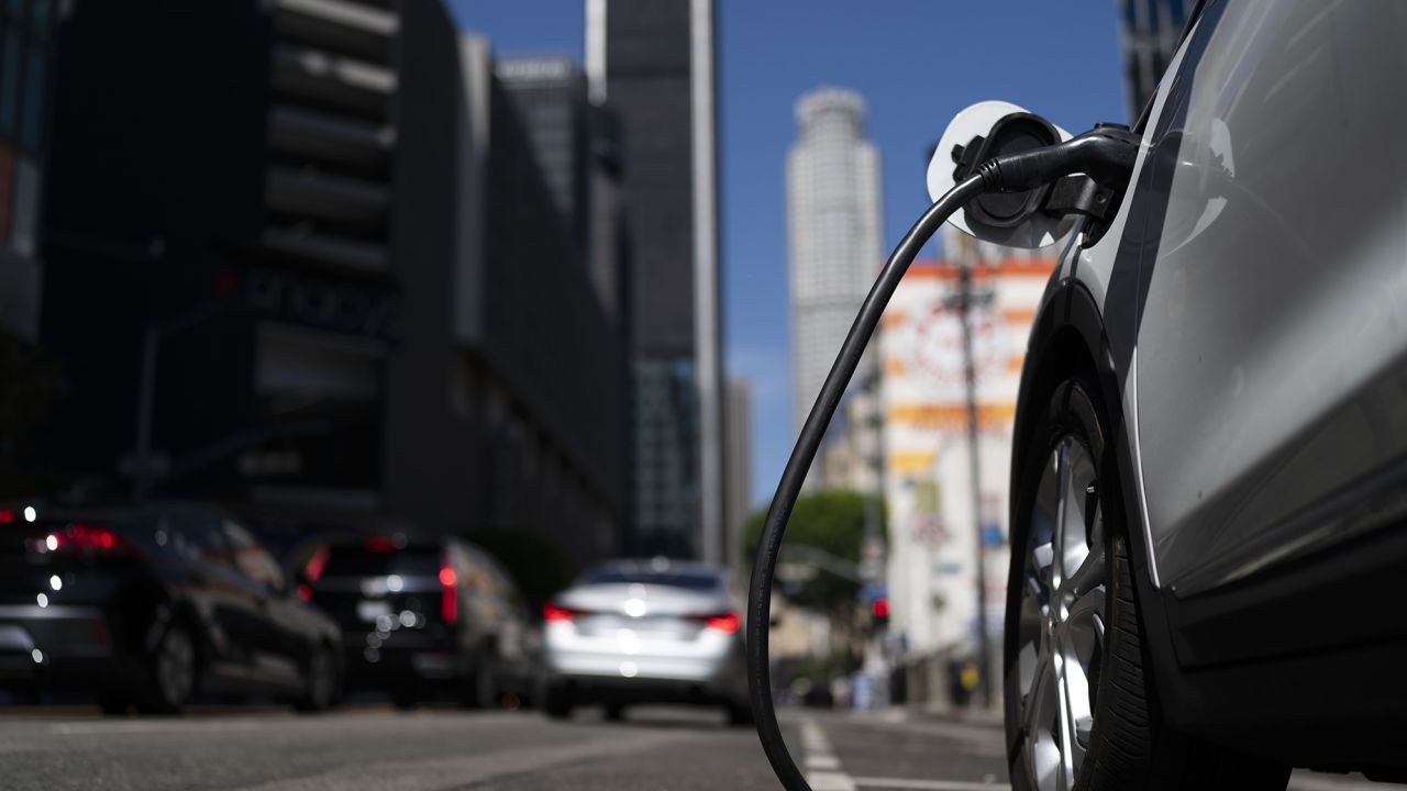 An electric vehicle is plugged into a charger in Los Angeles, Thursday, Aug. 25, 2022. 