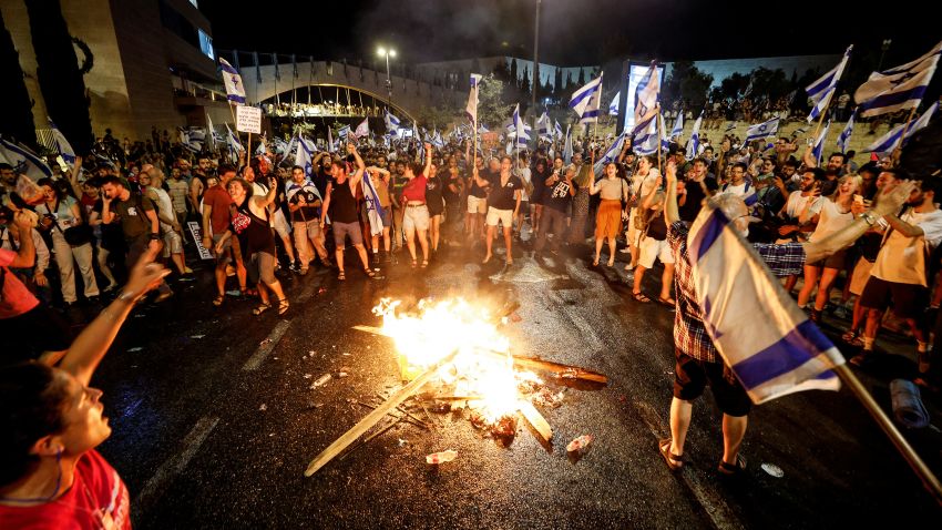 Protesters shout slogans next to a fire, during a demonstration, following a parliament vote on a contested bill that limits Supreme Court powers to void some government decisions, near the Knesset, Israel's parliament in Jerusalem July 24, 2023. REUTERS/Amir Cohen