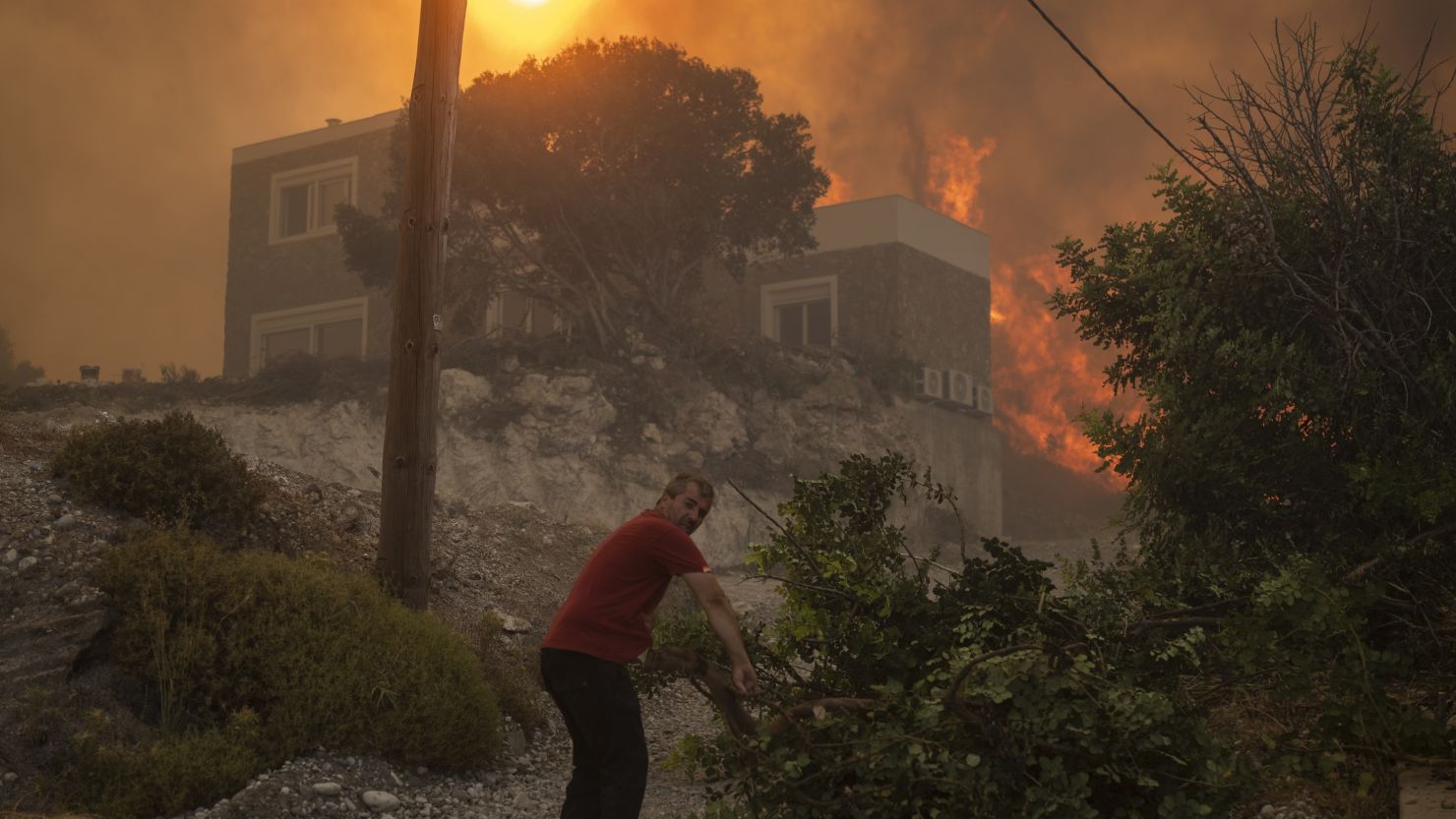 A wildfire burns in Gennadi village, on the Aegean Sea island of Rhodes, southeastern Greece, on Tuesday, July 25, 2023. 