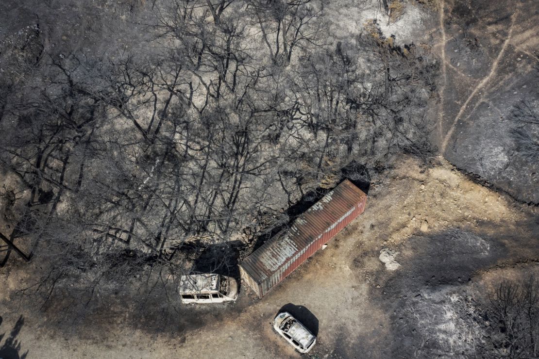An aerial view shows burnt vehicles and trees after a fire near Vati, on Rhodes, on July 26, 2023.