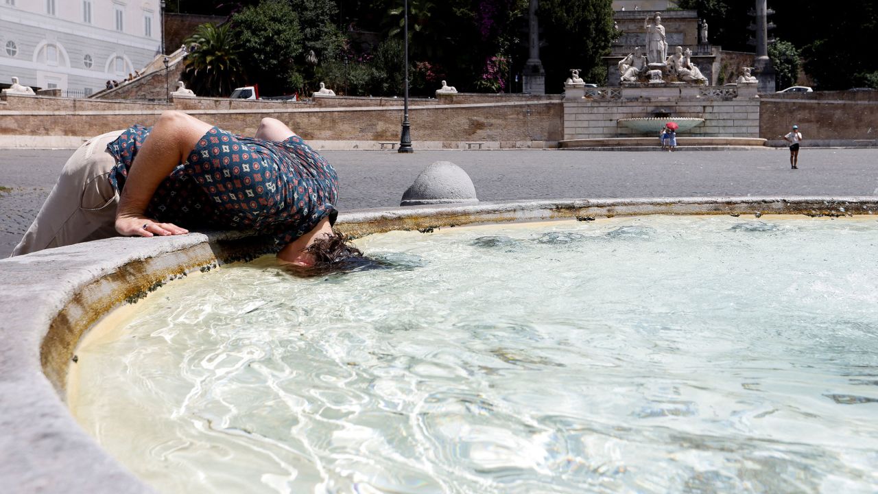 A person cools off during the heat wave at the Piazza del Popolo in Rome on July 18.