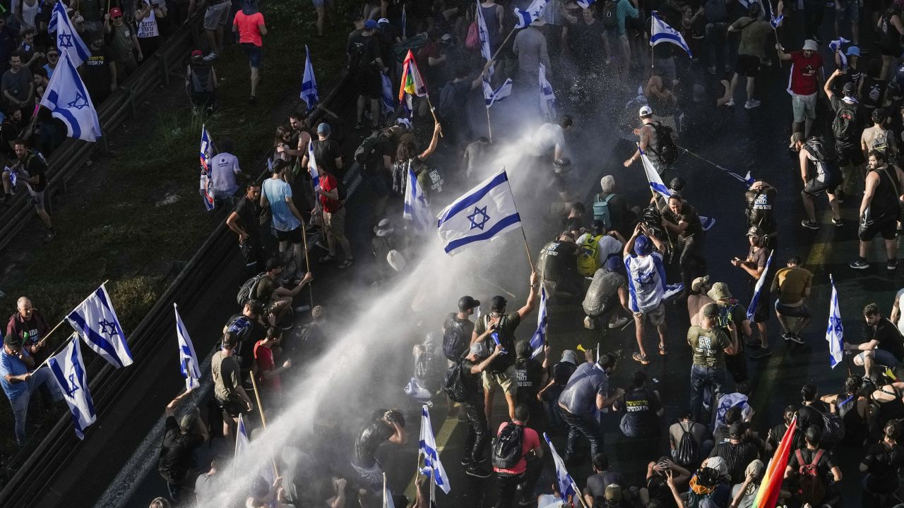 Israeli police use a water cannon to disperse demonstrators blocking a road during a protest in Jerusalem on Monday.