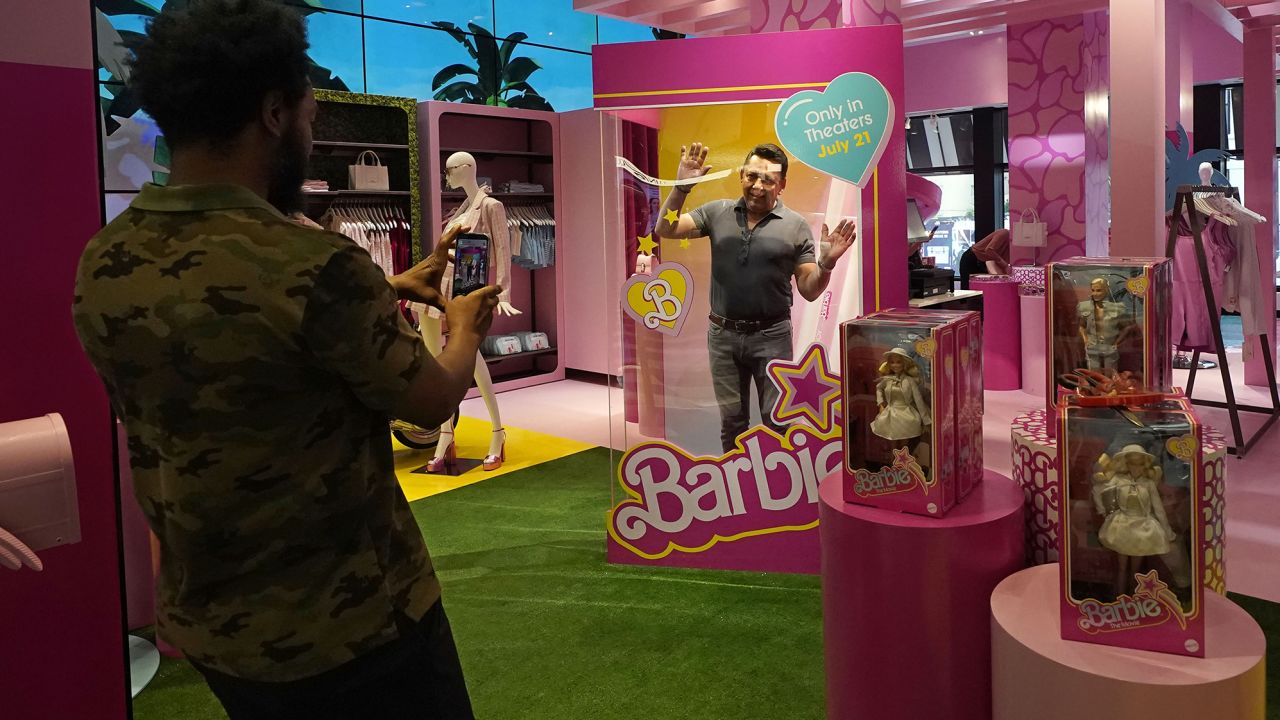 A man poses in a large Barbie doll box at Bloomingdale's in New York, ahead of the movie's release. 
