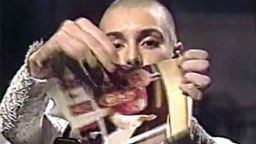 In October 1992, O'Connor made headlines around the world after a controversial performance on "Saturday Night Live" in which she ripped a photo of Pope John Paul II in half while saying, "Fight the real enemy." The protest was lampooned, and it ultimately harmed O'Connor's career because of the outrage.