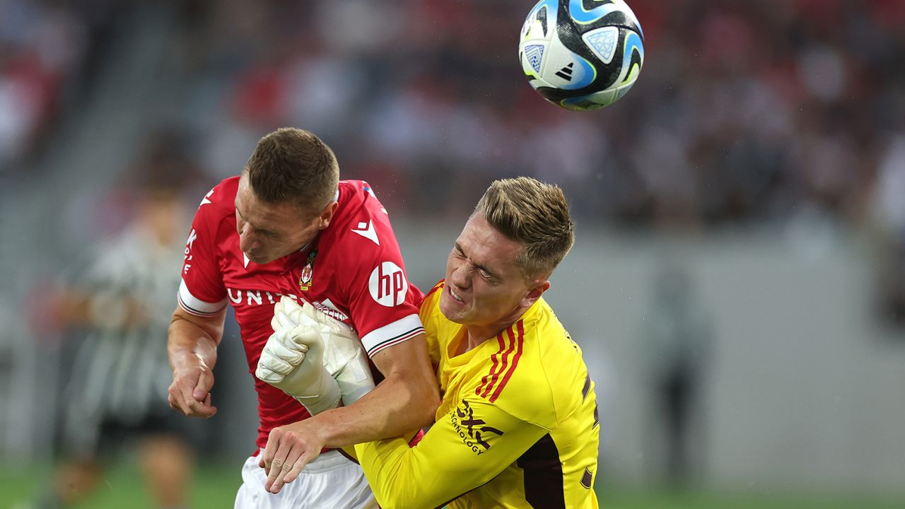 Paul Mullin #10 of Wrexham collides with Nathan Bishop #30 of Manchester United during the first half of a pre-season friendly match between Manchester United and Wrexham at Snapdragon Stadium on July 25, 2023 in San Diego, California.