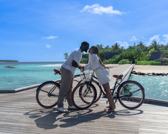 <strong>Good synergy:</strong> The couple say they have good "synergy" when they travel together. Here they are bike-riding in the Maldives.