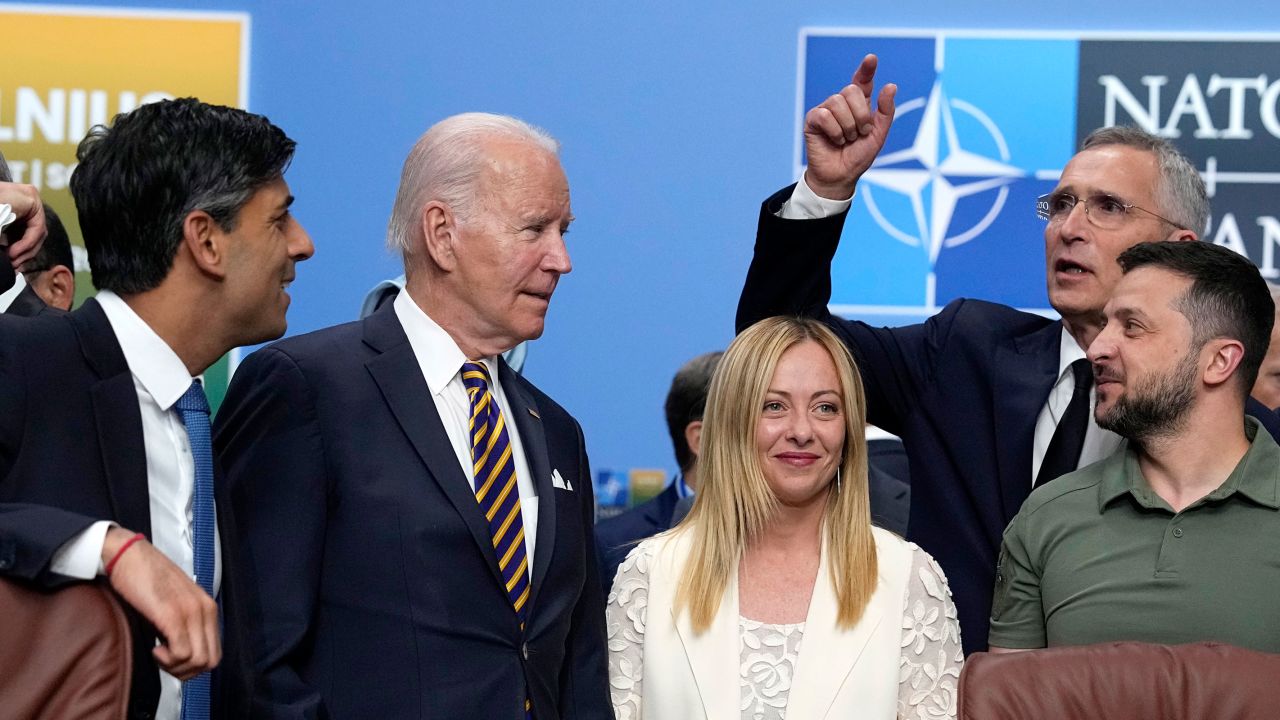 President Joe Biden and Italy's Prime Minister Giorgia Meloni wait to have their photo taken during a meeting of the NATO-Ukraine Council during a NATO summit in Vilnius, Lithuania, July 12, 2023.