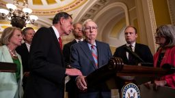 Sen. John Barrasso reaches out to help Senate Minority Leader Mitch McConnell after McConnell froze and stopped talking at the microphone during a news conference after a lunch meeting with Senate Republicans U.S. Capitol 26, 2023 in Washington, DC.