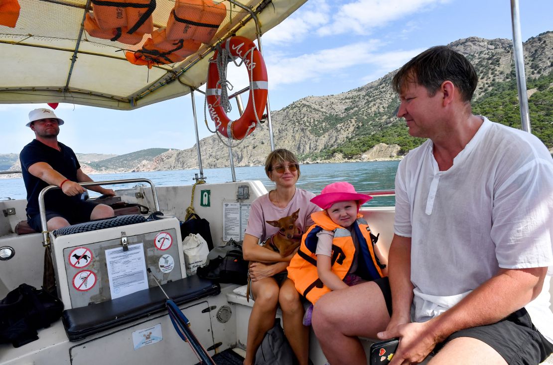 A family from Moscow takes a boat cruise on the Black Sea off the coast of Crimea on June 20, 2023.