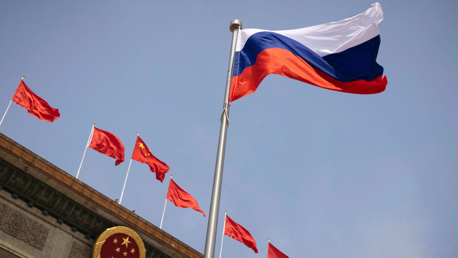The Russian national flag flies in front of the Great Hall of the People before a welcoming ceremony for Russian Prime Minister Mikhail Mishustin in Beijing, China, Wednesday, May 24, 2023.