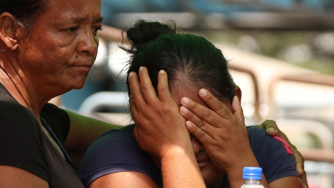 Relatives of prisoners at a penitentiary in Ecuador learn about the fatal clashes in Guayaquil on Tuesday, where dozens of bodily remains were recovered.