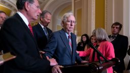 Senate Minority Leader Mitch McConnell is helped bySen. John Barrasso after the 81-year-old GOP leader froze at the microphones as he arrived for a news conference, at the Capitol in Washington, DC, on Wednesday, July 26, 2023.