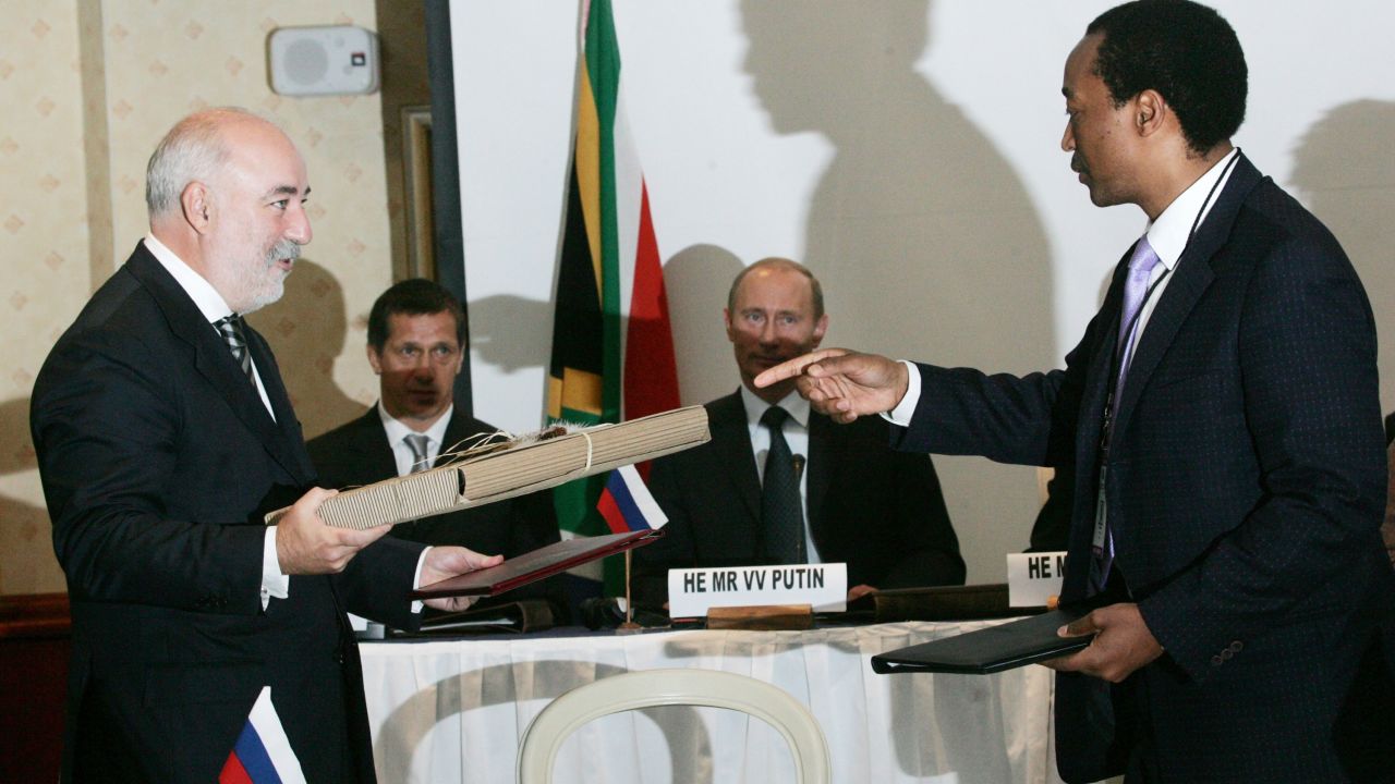 Russian President Vladimir Putin (third left), Russian oligarch Viktor Vekselberg (left), and then-Russian natural resources minister Yuri Trutnev (second left) attend a South African-Russian business forum in Cape Town, South Africa in September 2006.  