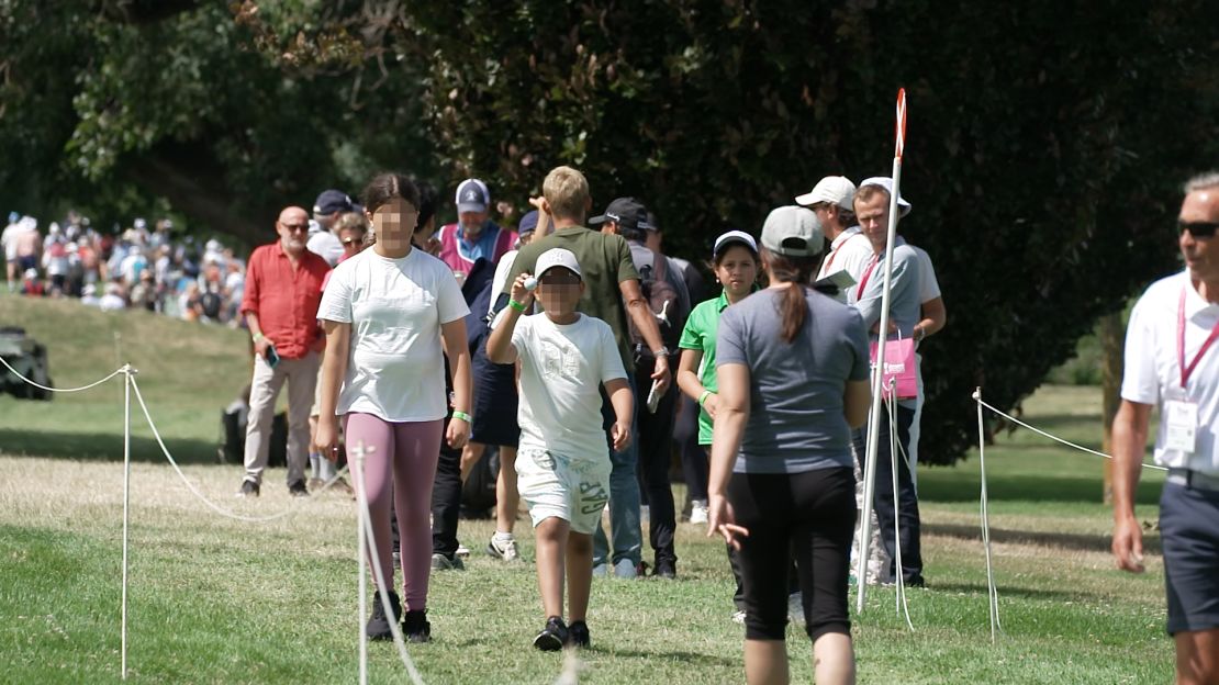 The boy and his sister return with balls signed by Angel Yin. A portion of this image has been blurred by CNN to protect identity.