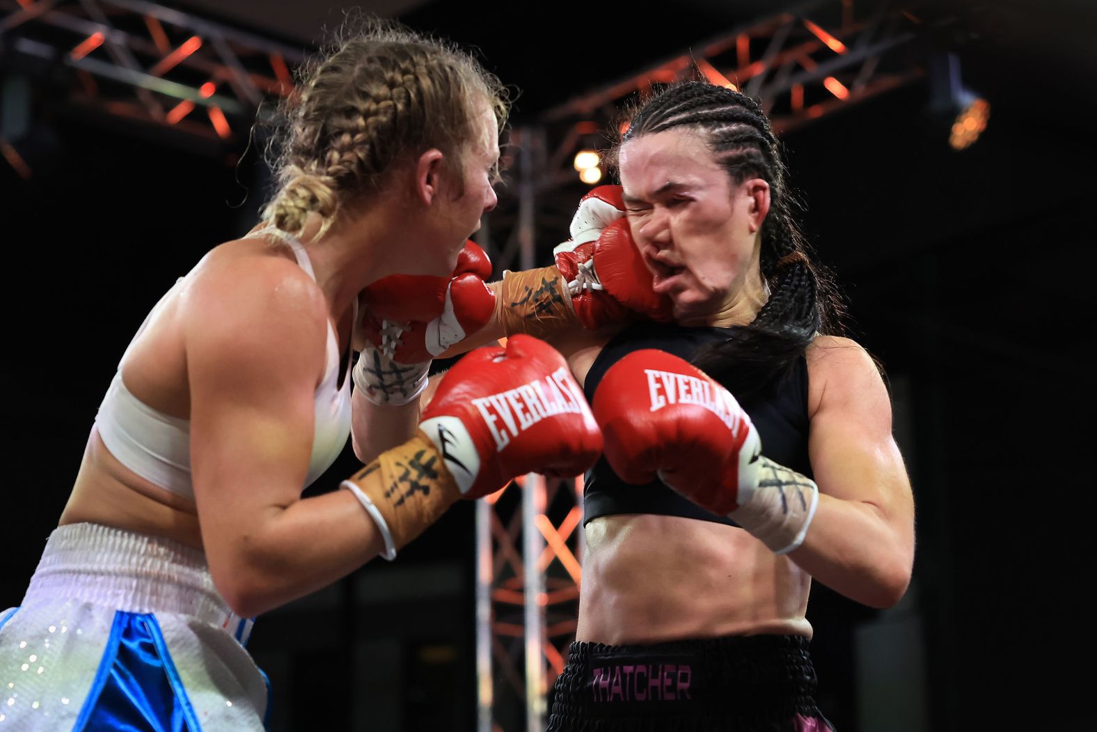 Boxer Ella Boot, left, punches Annie Thatcher during a bout in Sydney on Wednesday, July 26. Boot won by a unanimous decision.