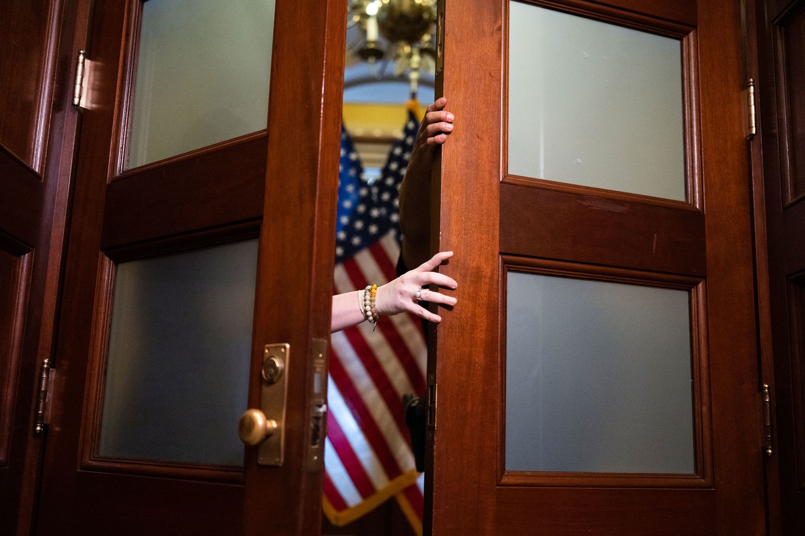 Staff and Capitol police prepare for House Speaker Kevin McCarthy to arrive at a news conference on Tuesday, July 25.
