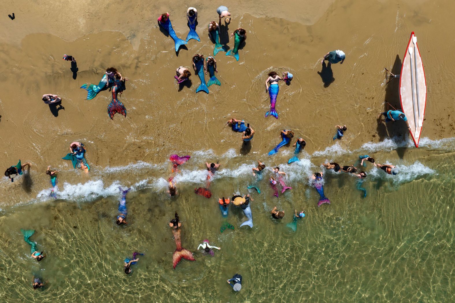 Members of the Israeli Mermaids Community swim in the Mediterranean Sea in Bat Yam, Israel, on Friday, July 21.