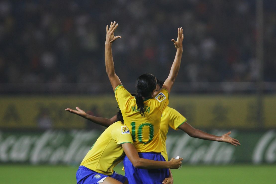 HANGZHOU, ZHEJIANG - SEPTEMBER 27:  Marta(10#)  of Brazil celebrates the winning with Monica(L 13#)  after the Womens World Cup 2007 Semi Final match between USA and Brazil at Hangzhou Dragon Stadium on September 27, 2007 in Hangzhou, Zhejiang province of China.  (Photo by Feng Li/Getty Images)