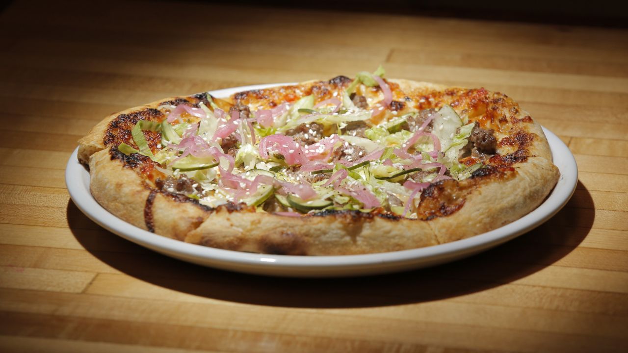 WESTBROOK, ME - SEPTEMBER 6: The Mac pizza, made with hamburger, 1000 island dressing, pickles, american cheese, red onion, romaine lettuce and sesame crust at 33 in Westbrook, photographed on Wednesday, September 6, 2017 for a review of bowling alleys that serve food. (Staff Photo by Gregory Rec/Staff Photographer)