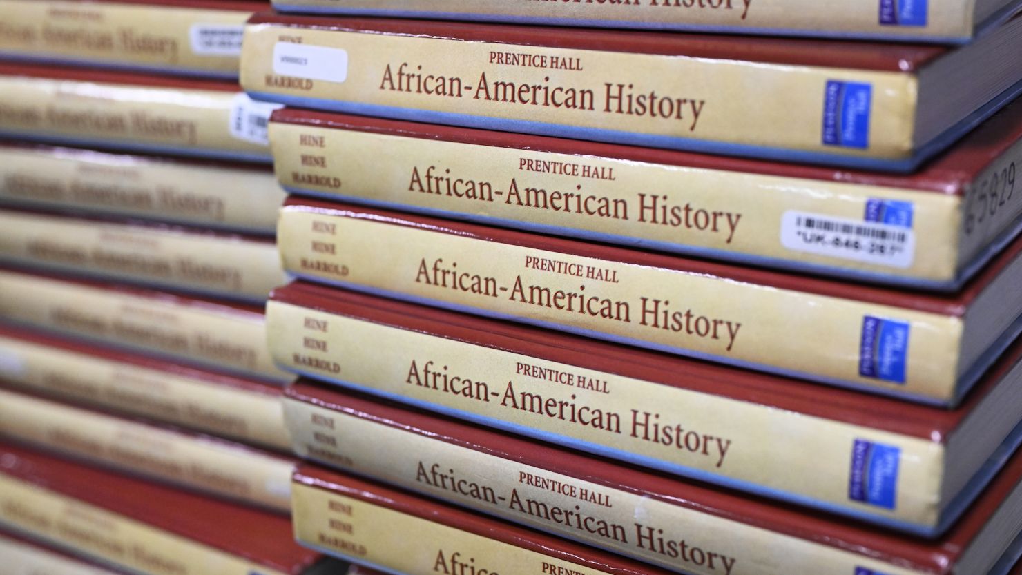 Books are piled in a classroom for students taking AP African American Studies at Overland High School in Aurora, Colorado, last fall.