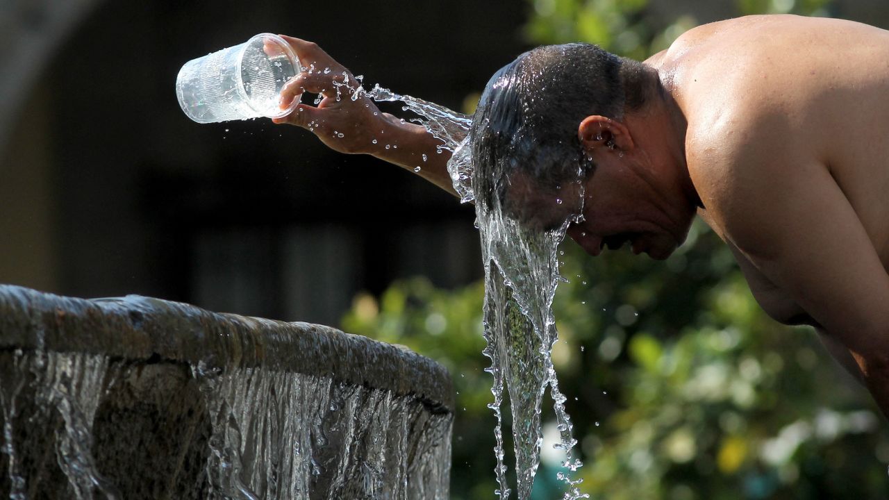 A man cools himself down with water from a water fountain during one of the hottest days of the third heat wave in Guadalajara, Jalisco state, Mexico, on June 12, 2023.
