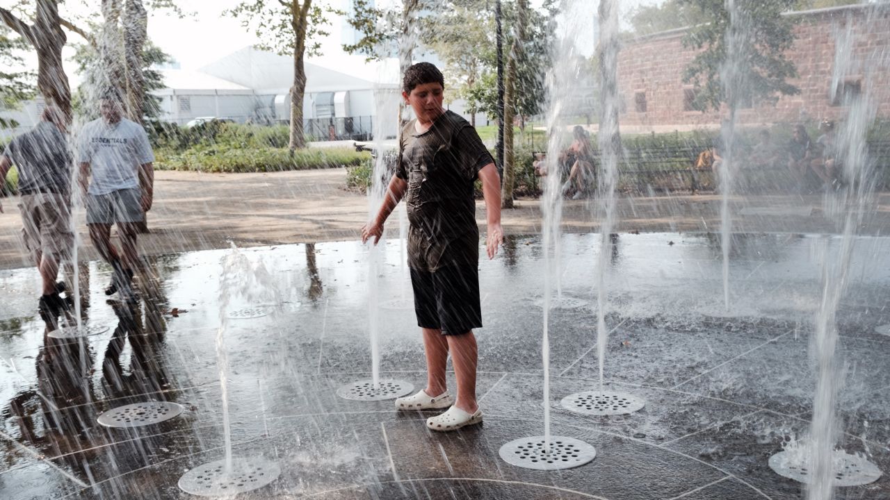 People keep cool in a fountain in Battery Park in Manhattan on Thursday, in New York City. 